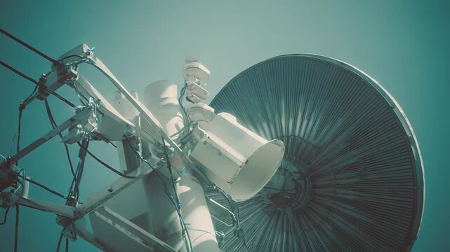 Satellite dish antenna equipment standing against a clear sky, highlighting modern telecommunication infrastructure, global connectivity, and signal transmission technology