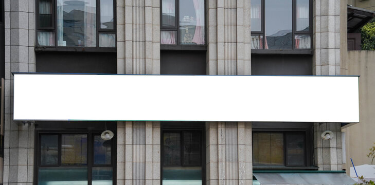 Blank billboard sign mockup in the urban environment on old building, facade, empty space to display your advertising or branding campaign