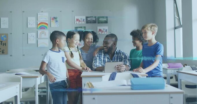 Male teacher tapping tablet to teach class lesson, students leaning in, following blue highlight