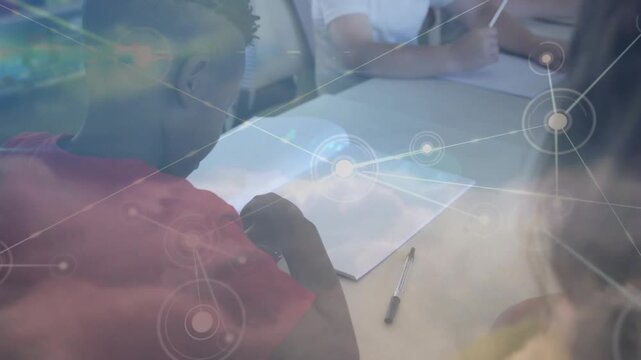 Girl in red shirt adjusting pencil grip practicing drawing as cloud overlay blending over classroom