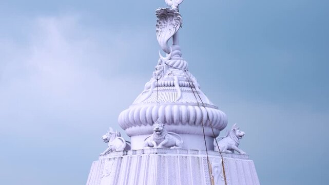 Decorative temple facade featuring deity sculptures and traditional Indian religious artwork in Odisha.