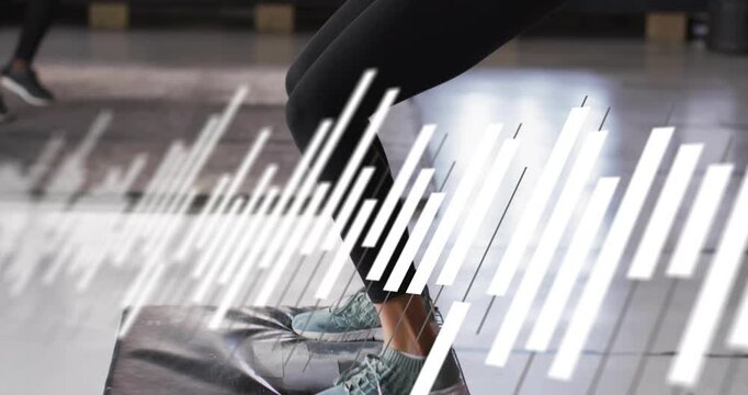 Woman planting feet and jumping onto plyo box, moving slanted bars sweeping over action for fitness