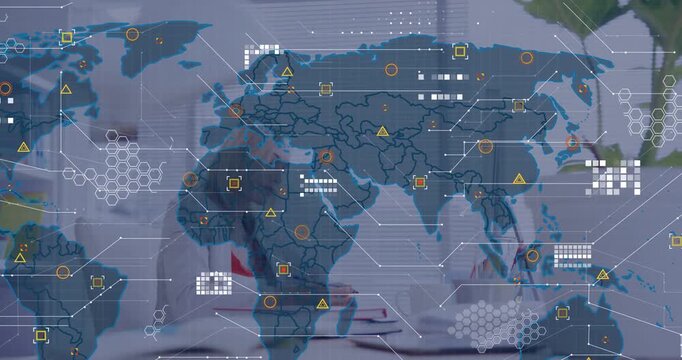 Vertical video: Typing woman at desk in blazer taking notes to analyze data as map appears