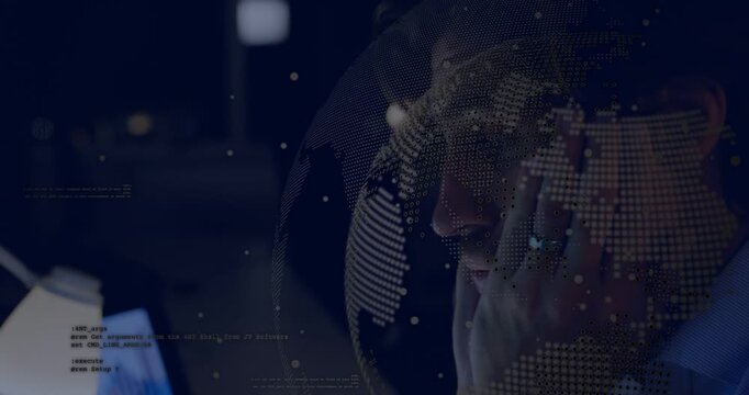 Vertical video: Pan showing man in shirt with headset rubbing eyes tired refocusing at screens HUD