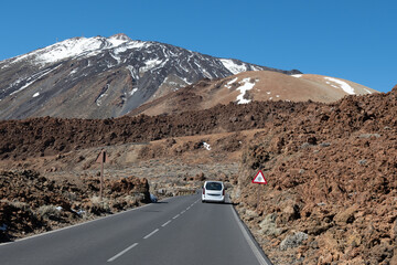 Visit of Mount Teide volcano national park in winter, snow on top of Teide, view on lavaf fields from road, driving car on Tenerife, Canary, © barmalini