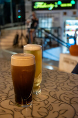 Evening in Irish pub with glasses of dark stour and ale beer, winter vacation on Tenerife, Spain © barmalini