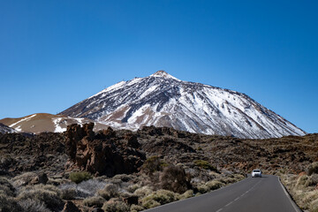 Visit of Mount Teide volcano national park in winter, snow on top of Teide, view on lavaf fields from road, driving car on Tenerife, Canary, © barmalini