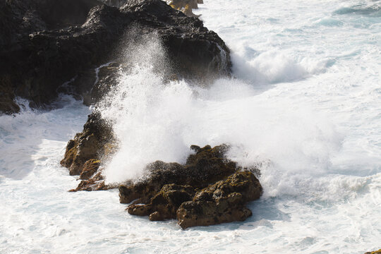 The waves crash powerfully against the rugged coastline of a North Atlantic island.