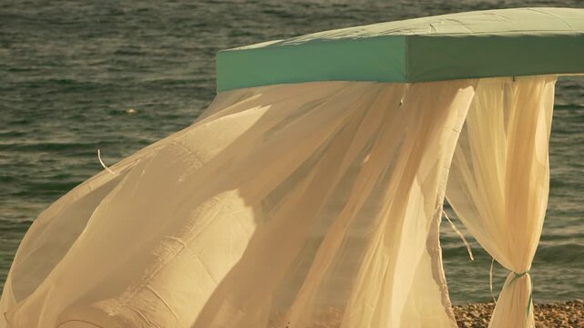 Bungalows sea. Beach Lounge bed with white silky curtains. Lounge bed with canopy at seaside. Beach Chairs and Sunshades. Summer Vacation resort concept.