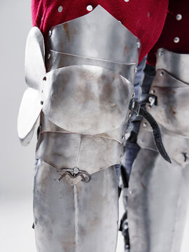 Medieval armor leg plating, showcasing intricate metal craftsmanship and historical design. historical equipment, medieval times, artisanal smithing intricacy, protective gear aesthetics