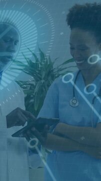 Vertical video: HUD showing Dr tapping tablet  and  nurse with steth pointing checking chart in clin