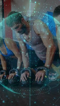 Vertical video: Pair doing KB pushups starting on KBs, syncing grips with globe overlay for fitness