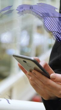 Tapping phone, woman scrolling thumb in mall, causing purple globe over hands, black top, railing