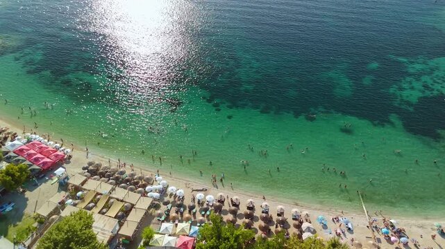 Aerial View of Limenas Beach with People Swimming in Thasos Greece