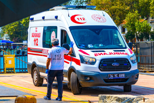 Istanbul, Turkey, August 8, 2025: Turkish Ministry of Health Ford Transit ambulance (112 Acil Sağlık) on duty in Turkey.A paramedic in a white uniform and blue gloves is standing near the vehicle. 