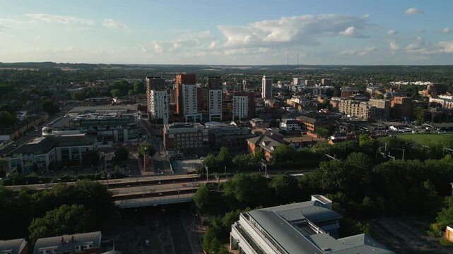 An aerial view of a modern urban landscape with a mix of high-rise buildings, residential areas, and lush green spaces.