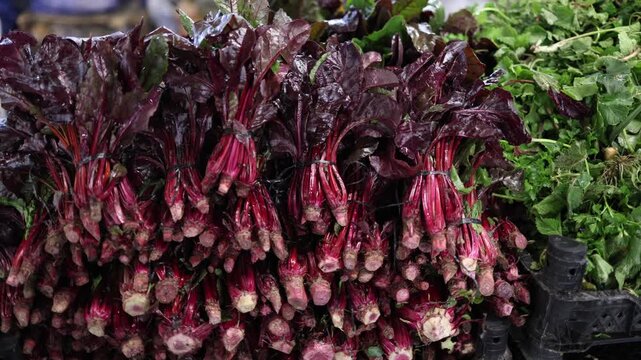 Fresh beetroot bundles with leaves on market display vibrant red stems organic vegetables healthy food farm produce natural harvest close up texture rustic grocery scene