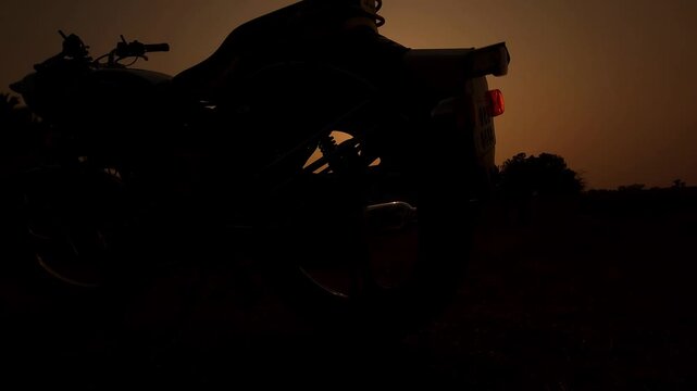 Motorcycle Silhouette at Sunset with Palm Trees Scenic Evening Landscape India