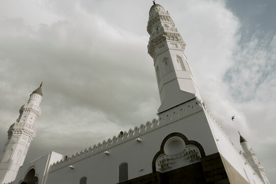 Quba mosque minarets soaring towards a cloudy sky, Medina, Saudi Arabia