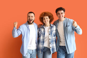 Obraz premium Group of young friends hugging on orange background