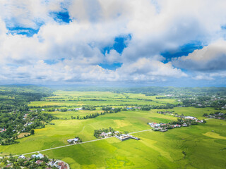 Obraz premium Waikabubak is the capital of West Sumba Regency, encircled by rice fields as seen from the hills, with the rice already turning yellow, awaiting the harvest