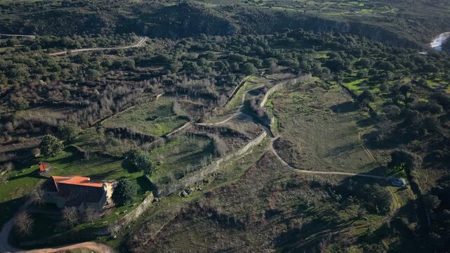 Aerial view of the ancient Vetton fortress of Yecla la Vieja, a pre Roman hillfort in Salamanca showing the stone walls, the landscape and the hermitage building