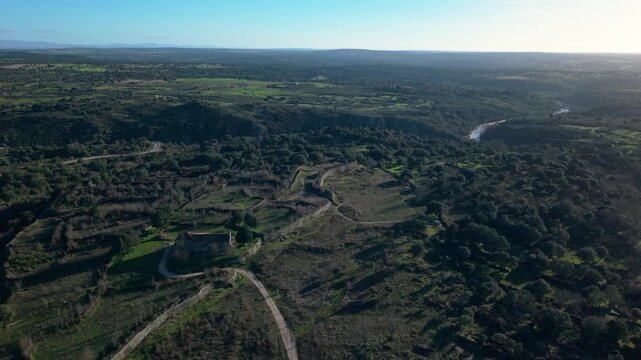 Scenic aerial view revealing the ancient Veton ruins of Yecla la Vieja Castro and the Yeltes river valley near Yecla de Yeltes, Spain, showcasing a historic landmark