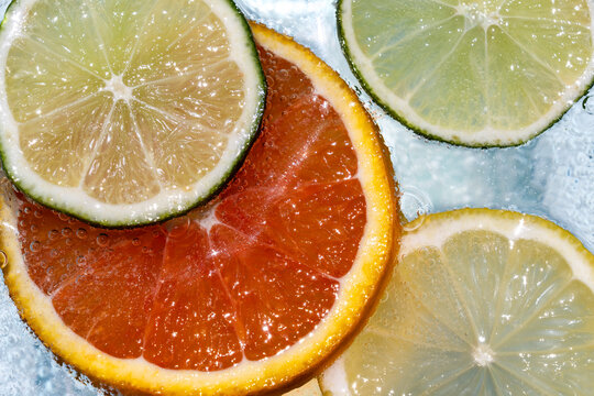 Citrus fruit floating in soda water 