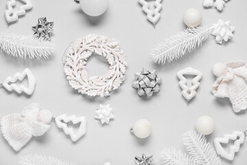 Naklejka premium Composition with Christmas balls, knitted angels and decorative snowflakes on white background