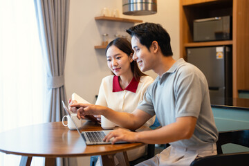 Fototapeta premium Happy young woman and man enjoying romantic family time in modern apartment. Married couple spending free weekend time together at home.