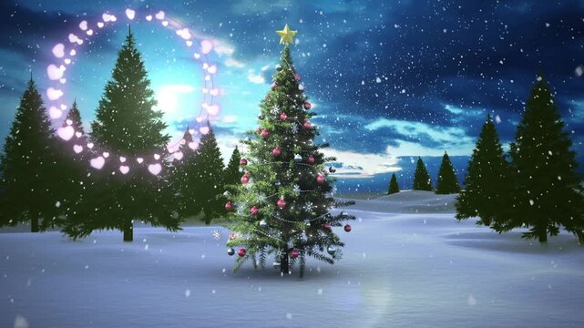Decorative shining lights against snowflakes falling over christmas tree on winter landscape