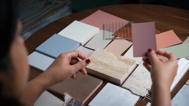 Interior designer and clients discussing tile and color options in her office - 4K stock video
