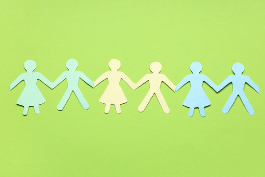 Paper human figures on green background
