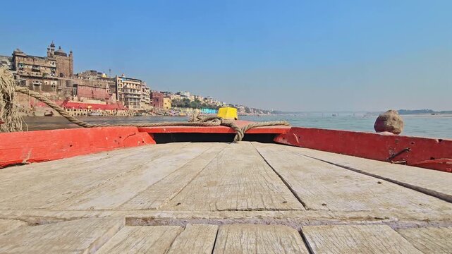 View from a moving boat on the Ganges River at Varanasi Ghats. Sacred river, historic Ghats, and spiritual atmosphere, showcasing Indian culture, rituals, and timeless heritage. Uttar Pradesh, India