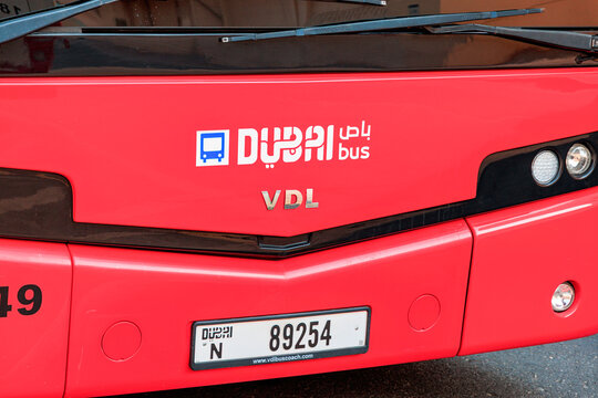 9 January 2026, Dubai, UAE: Red VDL branded bus front displaying branding and license plate. Daily urban commute vehicle