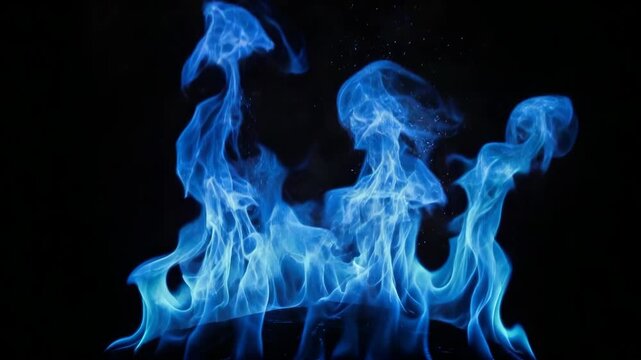 Intense blue fire burning with swirling wisps of smoke and gas against a dark isolated background