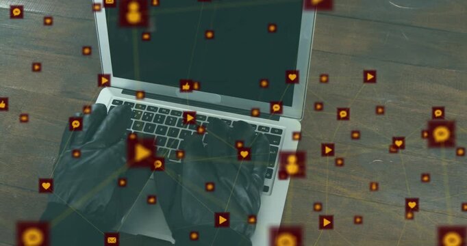 Animation of network of digital icons against mid section of a hacker wearing gloves using laptop