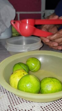 Squeezing fresh lime into a bowl