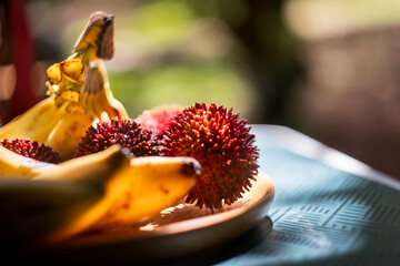 Fresh Rambutan and Bananas in Warm Sunlight © Denise