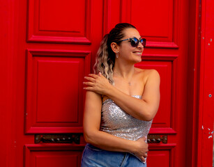 Fototapeta premium portrait of a beautiful young woman smiling at camera in old town 
