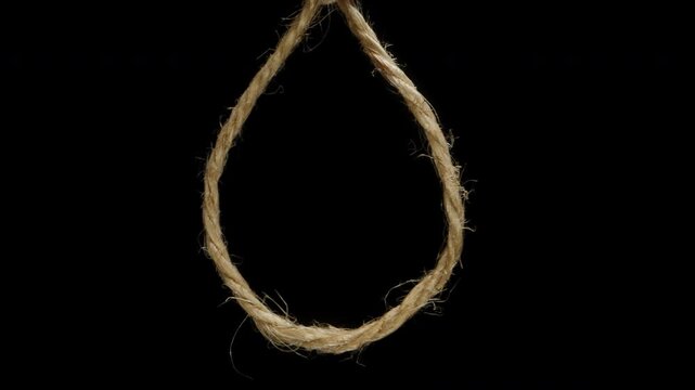 Sliding Through A Noose On A Rope, Isolated On A Black Background, Concept Of Being On The Brink Of Death