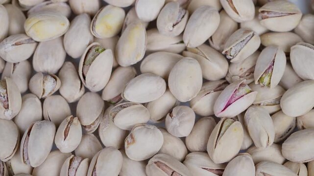 Salted pistachio shells and kernels. Closeup view of salted pistachio nuts for packaging. Detailed image of salted pistachios with shells and kernels seen from above