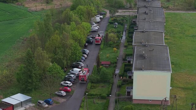 Volunteer firefighters from a rural Polish village celebrating Wet Monday (Śmigus-Dyngus), joyfully splashing water and playing with local residents in a festive spring tradition