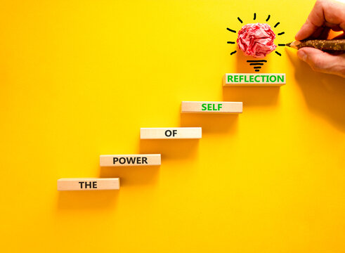 Self reflection symbol. Concept words The power of self reflection on beautiful wooden blocks. Beautiful yellow background. Businessman hand. Business the power of self reflection concept. Copy space.