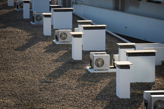 The external units of the commercial air conditioning and ventilation systems are installed on the roof of an industrial building