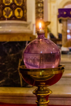 Ornate Antique Glass Lamp With Gold Metal Stand and Warm Glowing Light in Interior