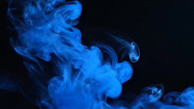 Vibrant blue ink swirling abstractly in dark water