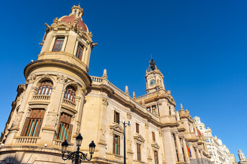 Obraz premium Tower of the classic building of the city hall of Valencia on a sunny day with blue skies, Spain.