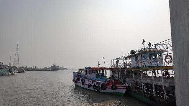 Passenger Ferry Boats Docked at River Jetty with Industrial Background