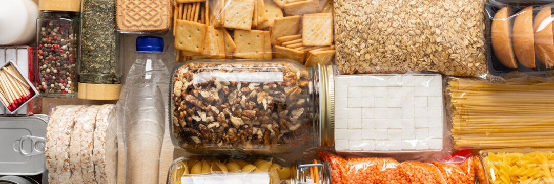 Essential home food stock for military operations and crises and for the period of quarantine and isolation, canned food, pasta, flour and nonperishable items,the concept of stay at home, banner